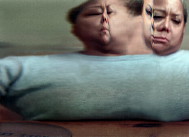 Blurred image of a woman showing her face from multiple angles