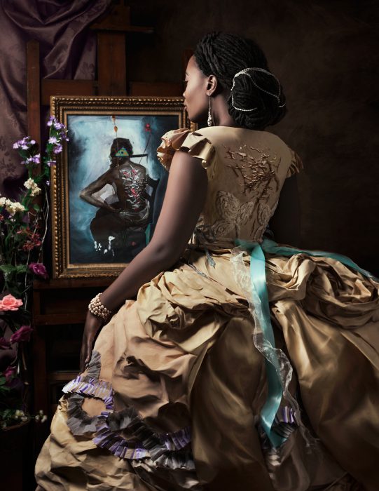 African American woman in a renaissance dress looking at a painting of an African American