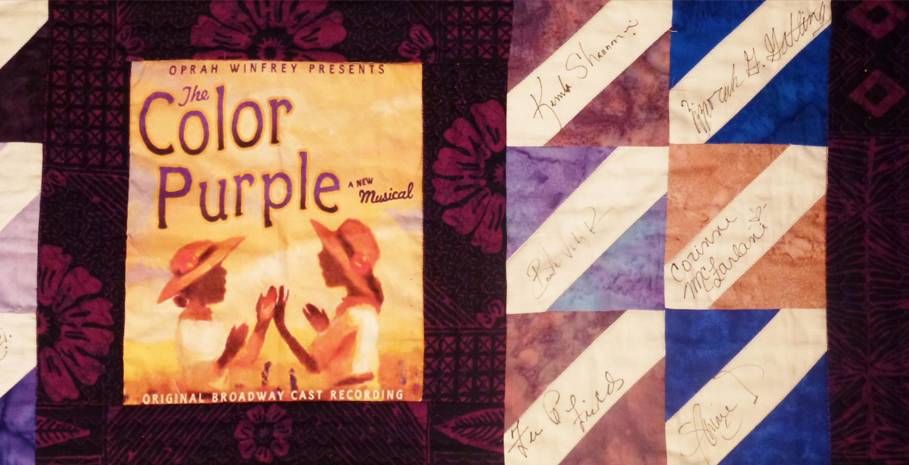 A quilt decorated with the cover of the book, "The Color Purple"