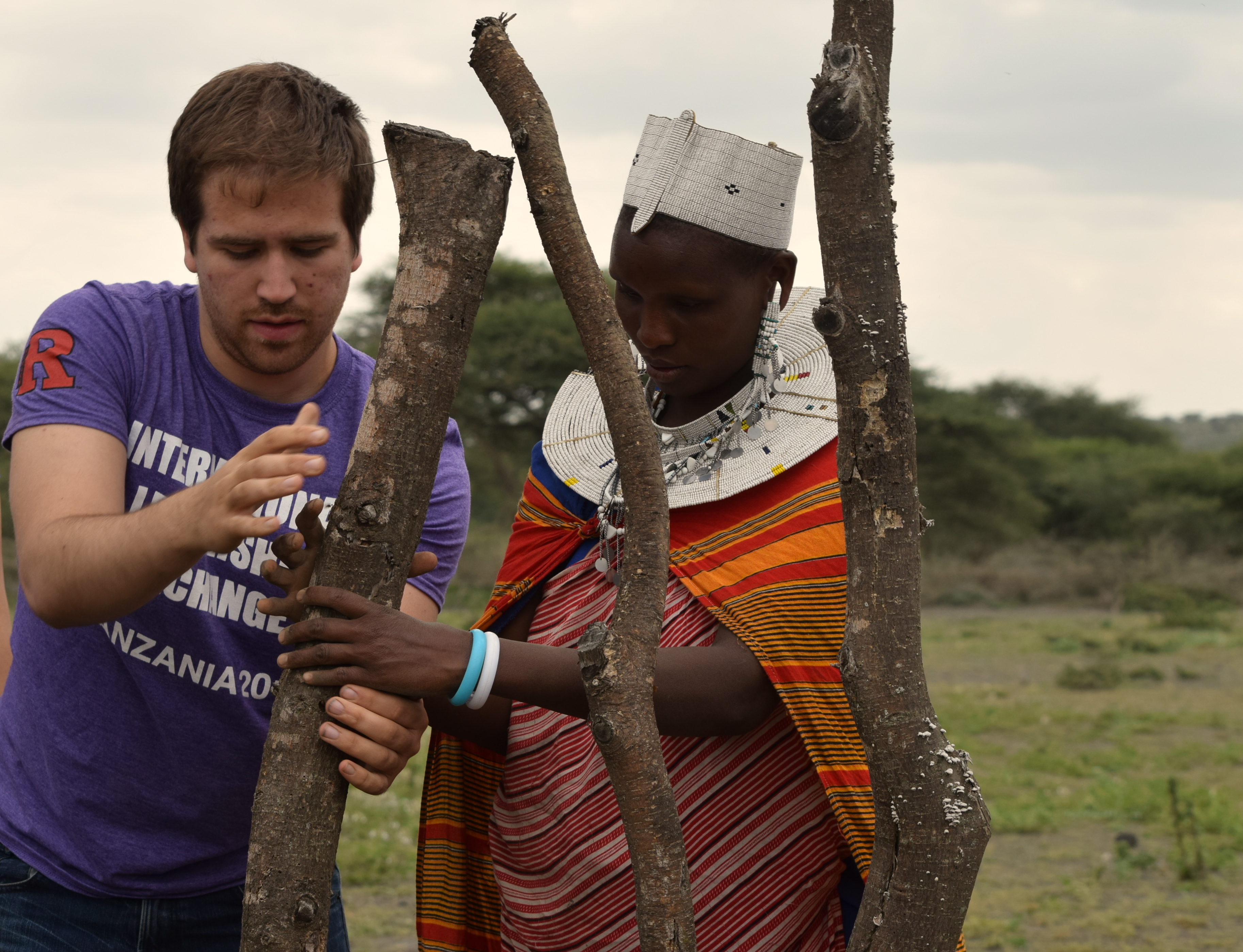 A Rutgers student aids a Tanzanian in their work