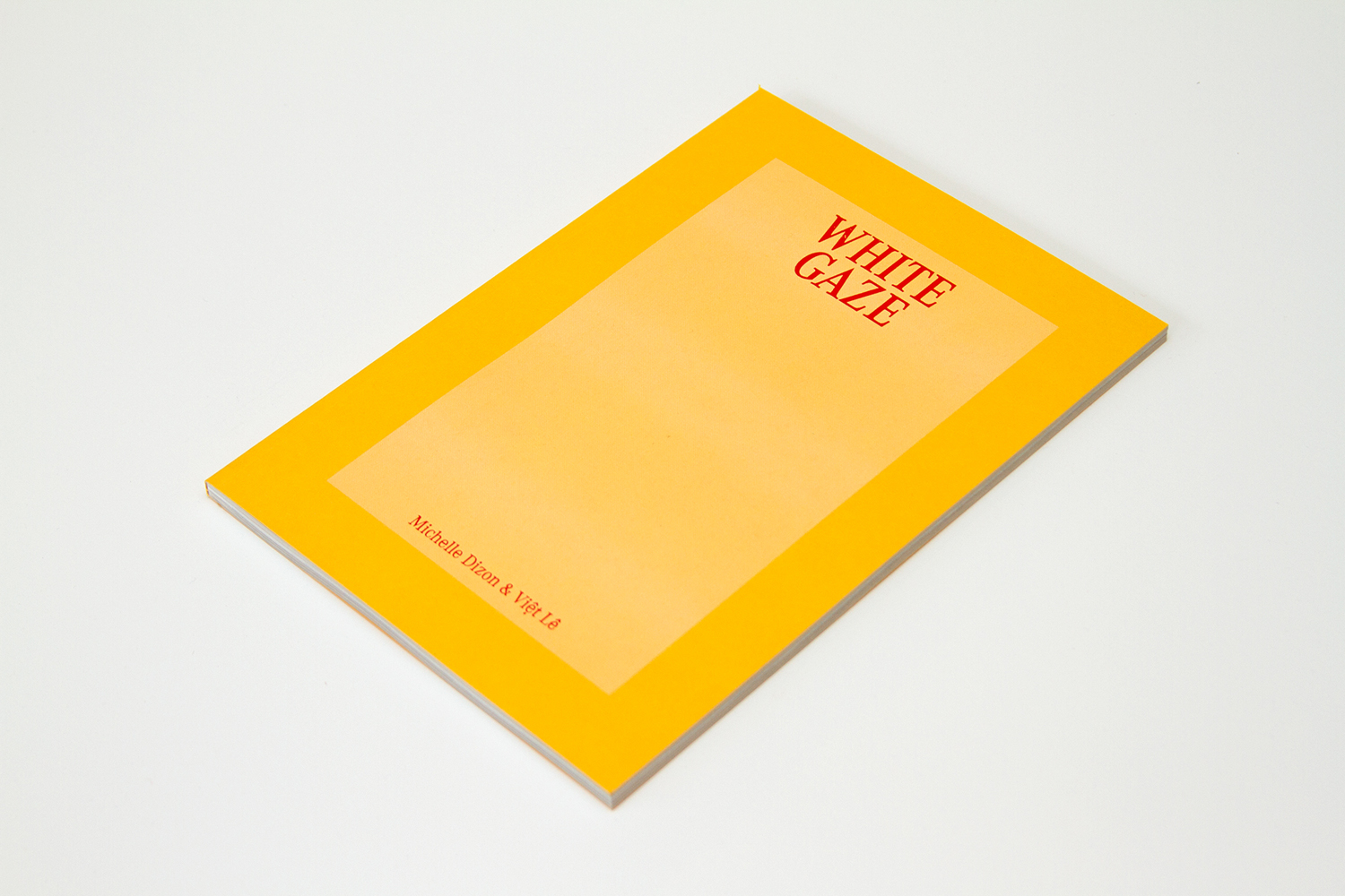A yellow book with the title, White Gaze