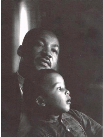 Photo of Martin Luther King, Jr. seated with child